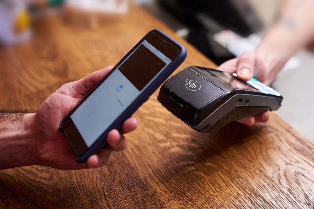 Mobile phone using digital wallet to pay on credit card terminal